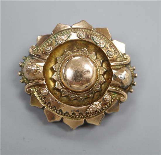 A Victorian embossed yellow metal brooch, with glazed back, 37mm.